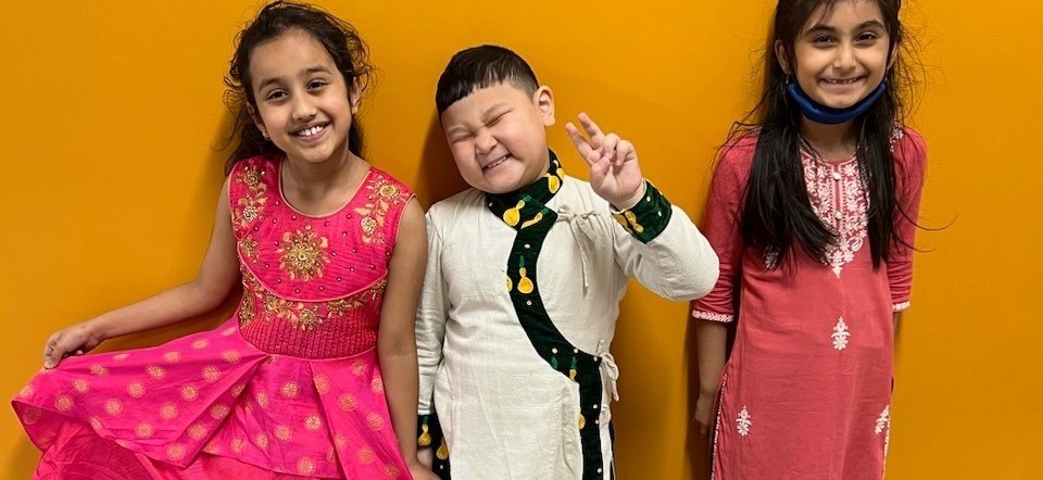 three Struble  Multicultural Club students wearing cultural wear 
